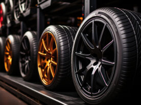 Car tires showcased inside an automobile workshop.